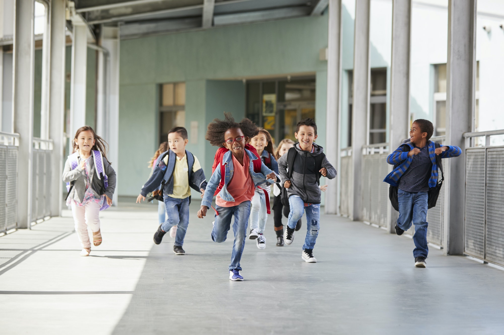 Elementary school kids running in a corridor in the school