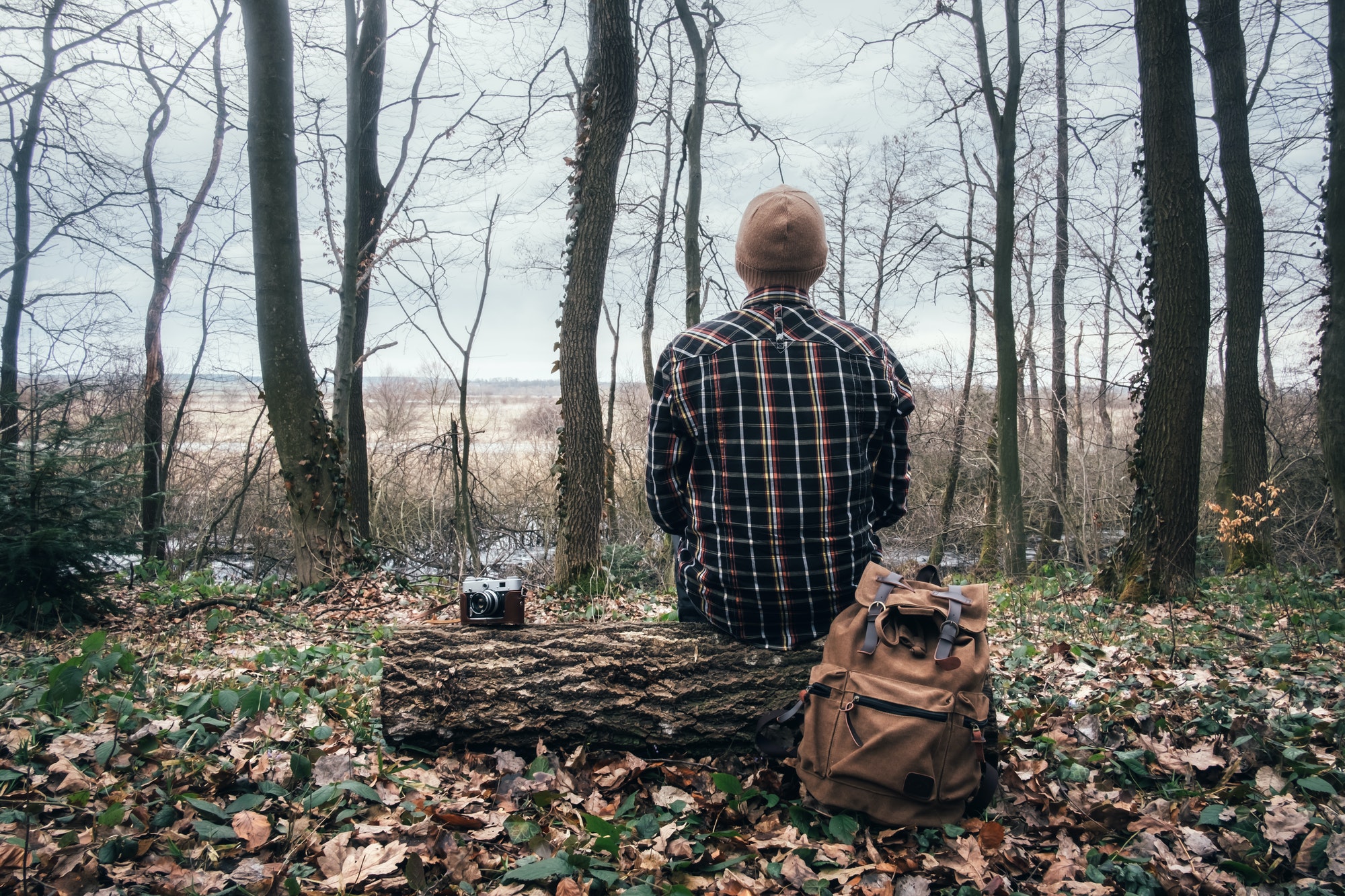 Man with backpack in wild forest